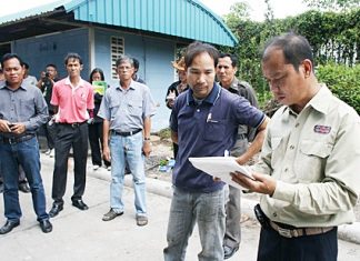 Bankai Sub-district Mayor Sanit Putsang instructs a Mit Steel manager to clean drains and construct a storage tank in order to reduce toxic effects on the neighboring villagers.